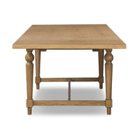 Front view of the Menorca Extension Dining Table, featuring a warm wood finish and elegant turned legs.