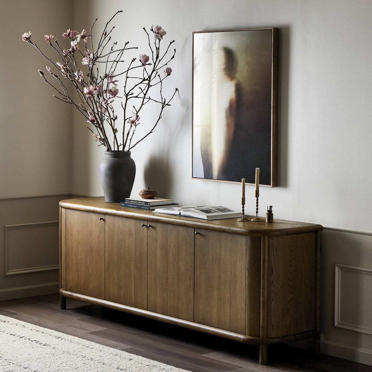Elegant Laurent Sideboard in amber oak, featuring smooth curves and four cabinet doors.