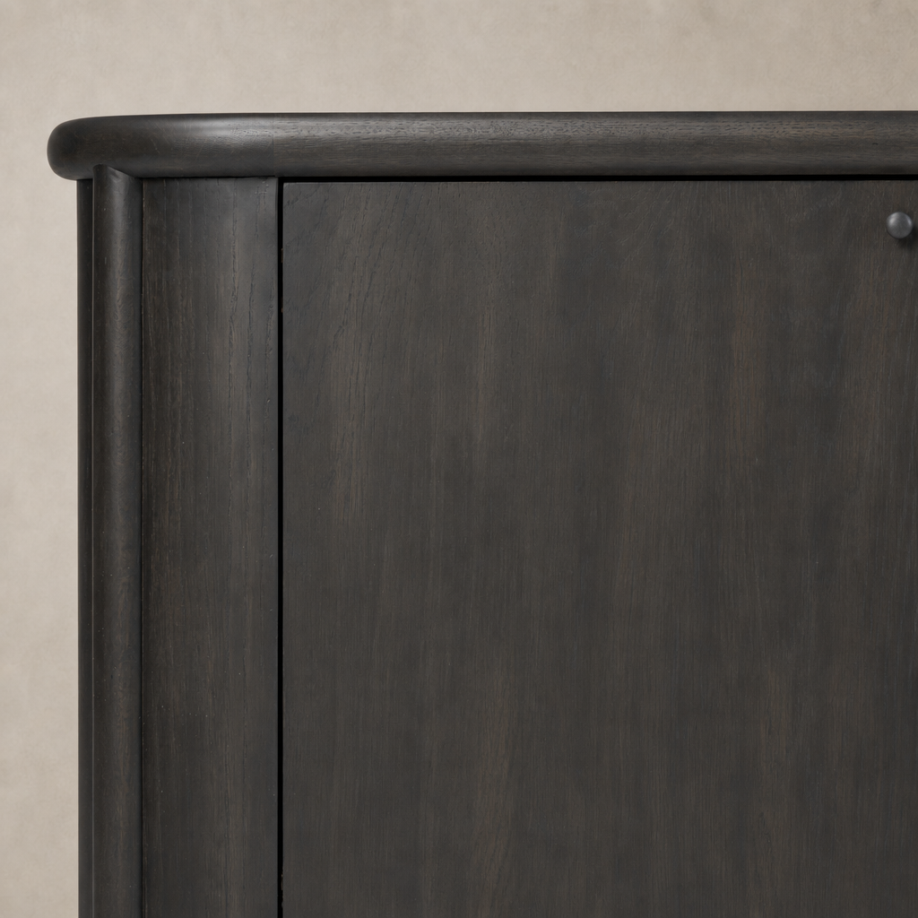Close-up of the Laurent Sideboard in smoked black solid wood, highlighting its smooth finish and rounded edges.