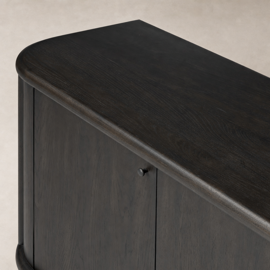 Close-up of Laurent Sideboard in smoked black solid wood, highlighting rounded edges and smooth finish.
