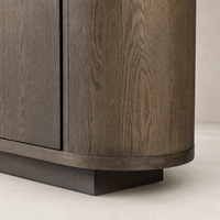 Eleni Sideboard in weathered dark oak, featuring a sleek curved design and rich texture.
