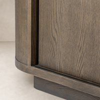 Eleni Sideboard in weathered dark oak showcasing a smooth, rounded edge and textured wood grain.