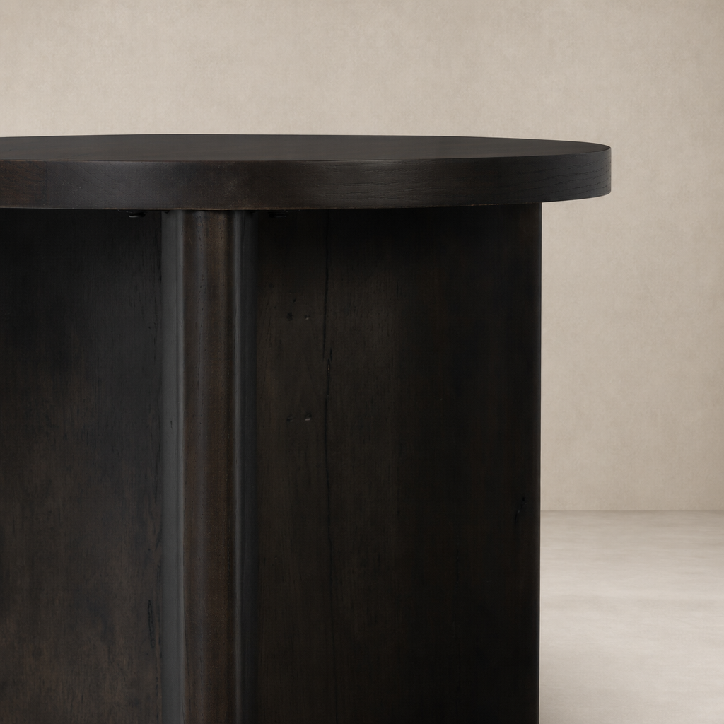 Rumi End Table featuring a sleek, round dark wood surface and sturdy cylindrical base.