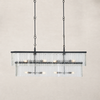 Linear chandelier with antiqued iron finish and textured glass panels.