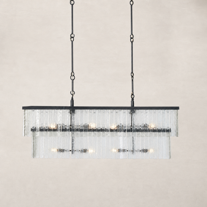 Linear chandelier with antiqued iron finish and textured glass panels.