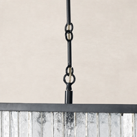 Antiqued iron linear chandelier showcasing chain detail and reflective glass panel.