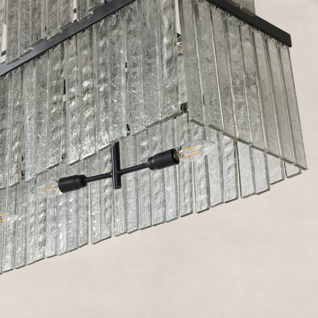 Linear chandelier in antiqued iron with textured glass panels and unique lighting design.