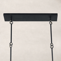 Antiqued iron linear chandelier with hanging chains and a sleek rectangular ceiling plate.