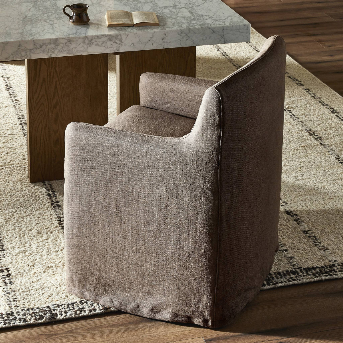 Slipcover dining chair in Brussels Mushroom color with curved back and soft fabric.