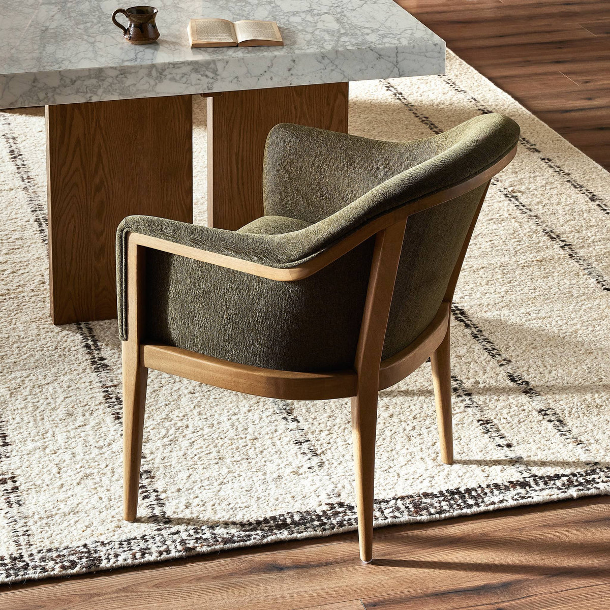 Preston Dining Chair in Sutton Olive features a curved back and wooden legs.