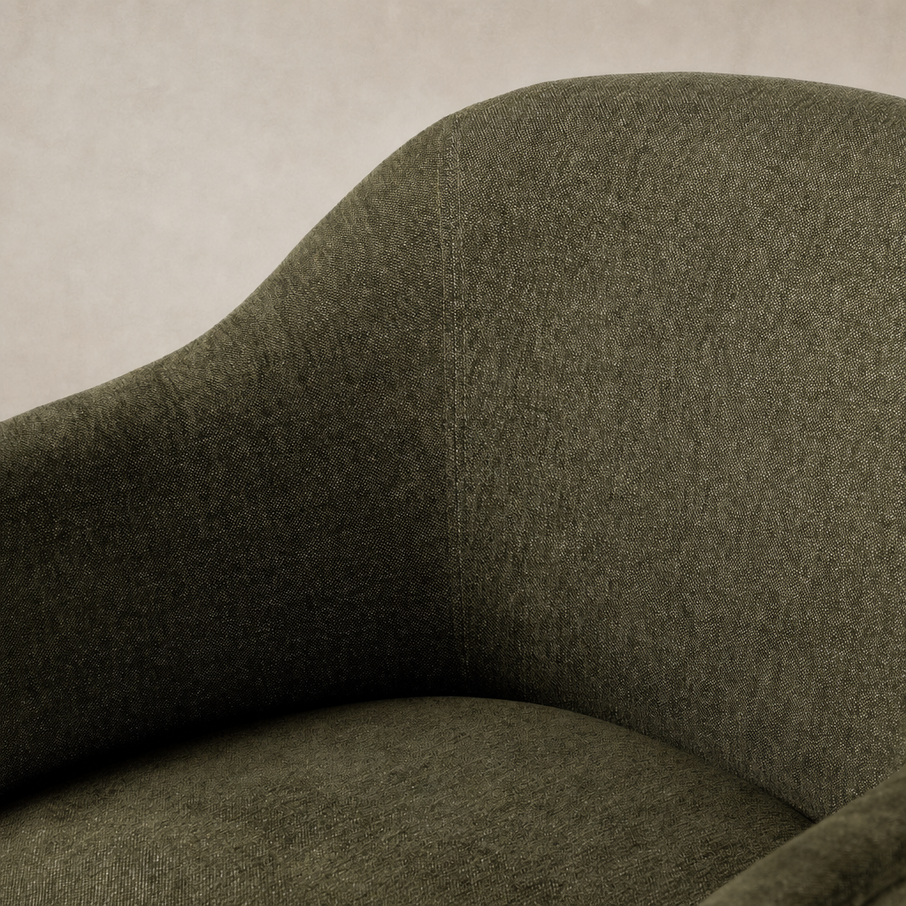 Close-up of the Preston Dining Chair in Sutton Olive showcasing its soft fabric texture and curves.