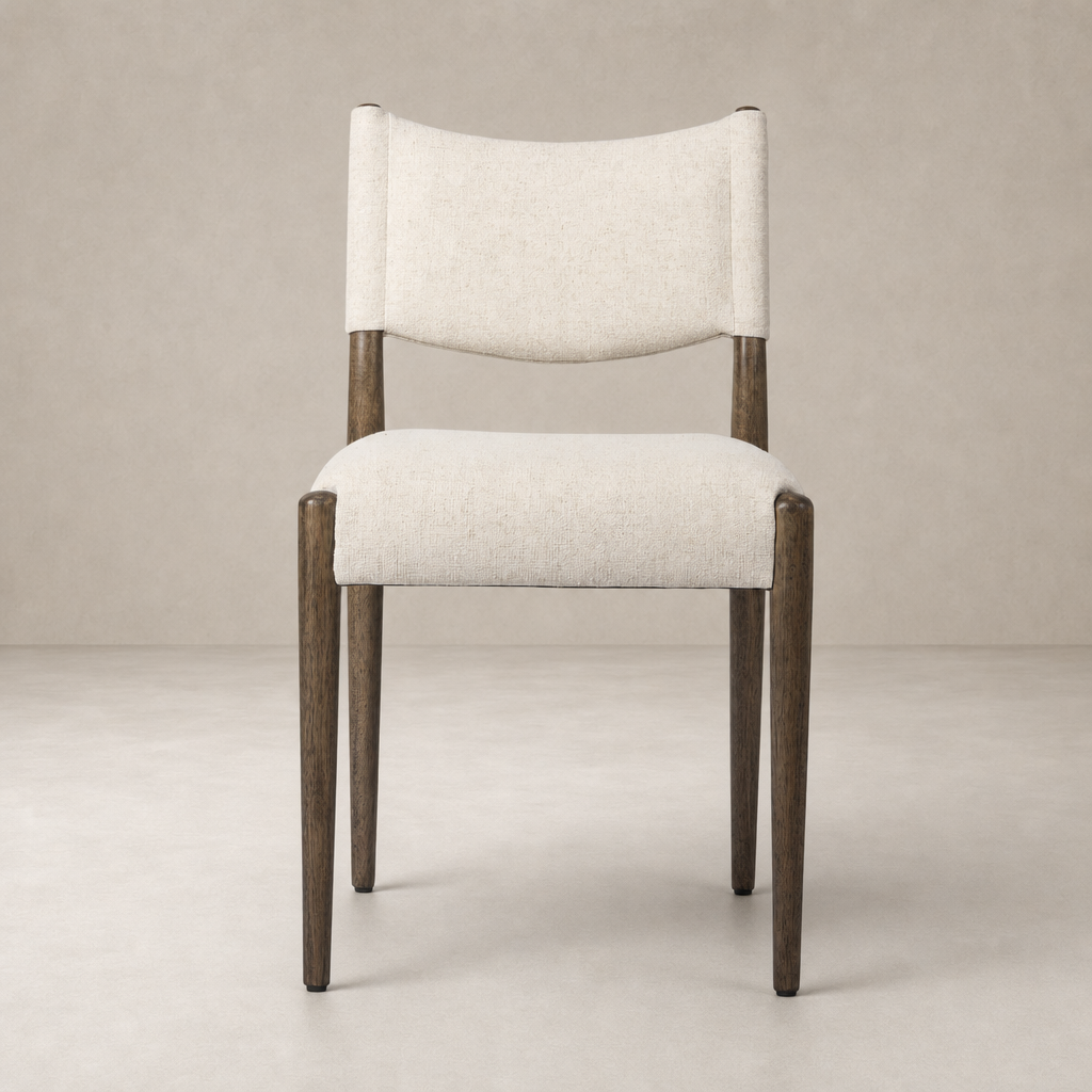 Mira Armless Dining Chair in Antwerp Natural with soft fabric and sleek wooden legs.