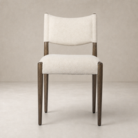 Mira Armless Dining Chair in Antwerp Natural with soft fabric and sleek wooden legs.