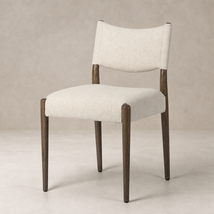 Mira Armless Dining Chair in Antwerp Natural with soft fabric and stylish wood legs.