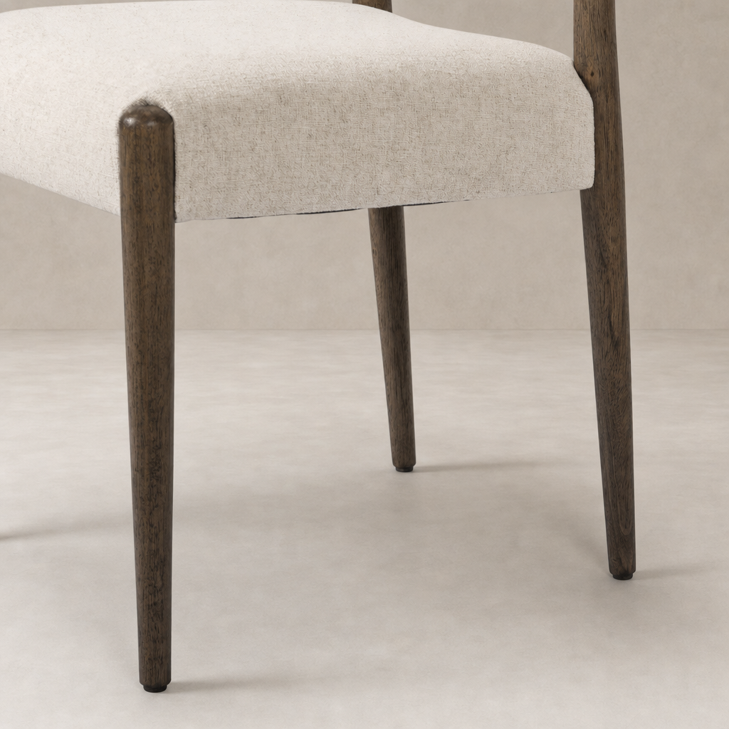 Mira Armless Dining Chair in Antwerp Natural with textured fabric seat and wooden legs.