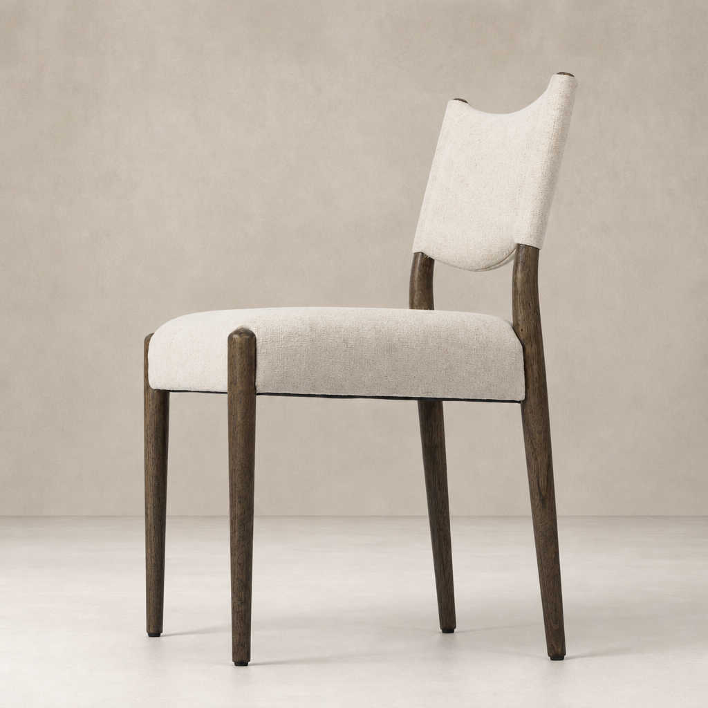 Mira Armless Dining Chair in Antwerp Natural features a textured upholstery and sleek wooden legs.