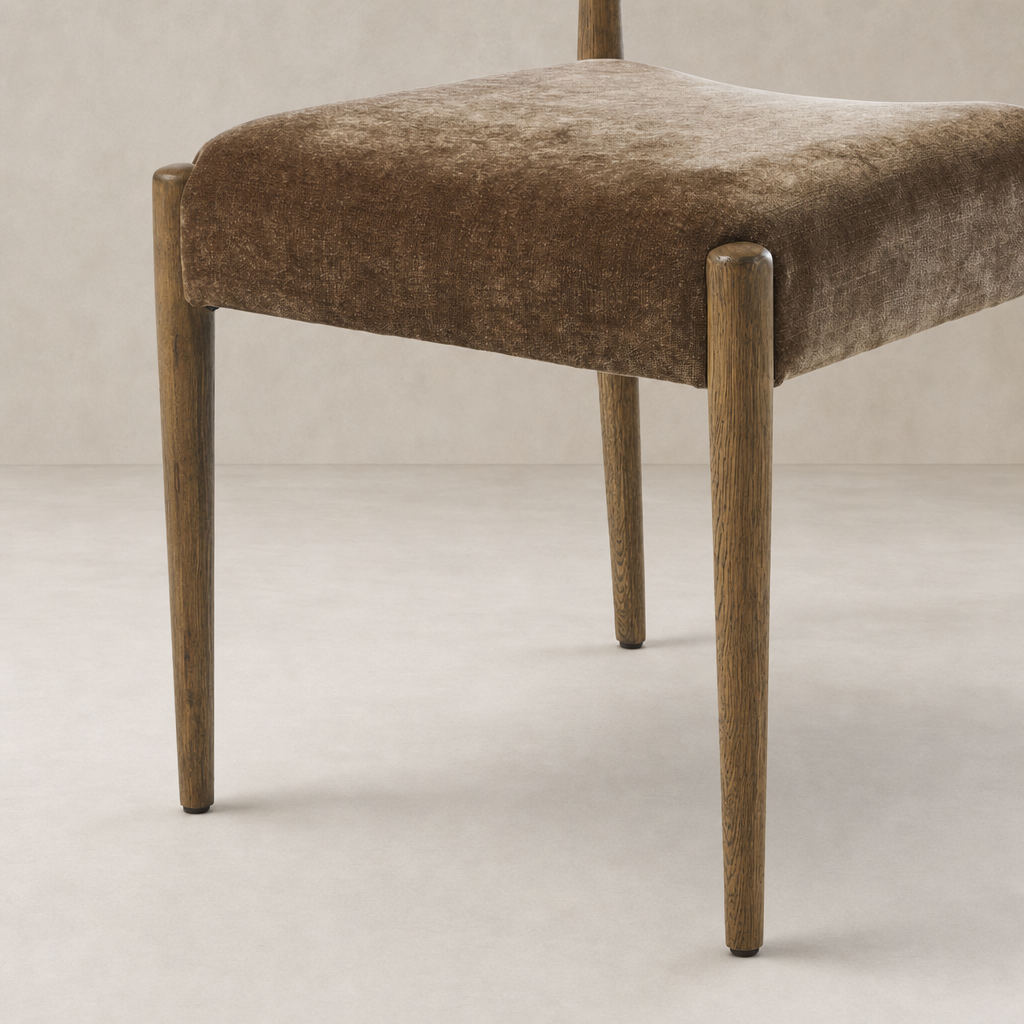 Mira Armless Dining Chair in Altair Mushroom with sleek wooden legs and soft texture.