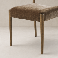 Mira Armless Dining Chair in Altair Mushroom with sleek wooden legs and soft texture.