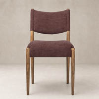 Mira Armless Dining Chair in Laughlin Plum with wood legs and a curved back design.