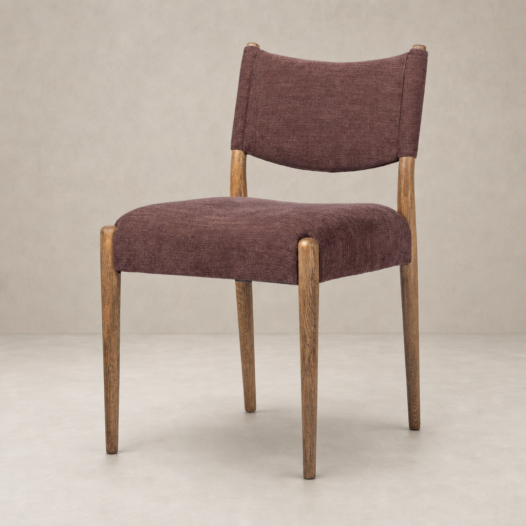 Mira Armless Dining Chair in Laughlin Plum with wooden legs and textured upholstery.