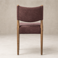 Mira Armless Dining Chair in Laughlin Plum with wooden legs and textured upholstery.