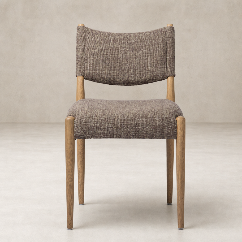 Mira Armless Dining Chair in Saxon Mink with a curved back and wooden legs.