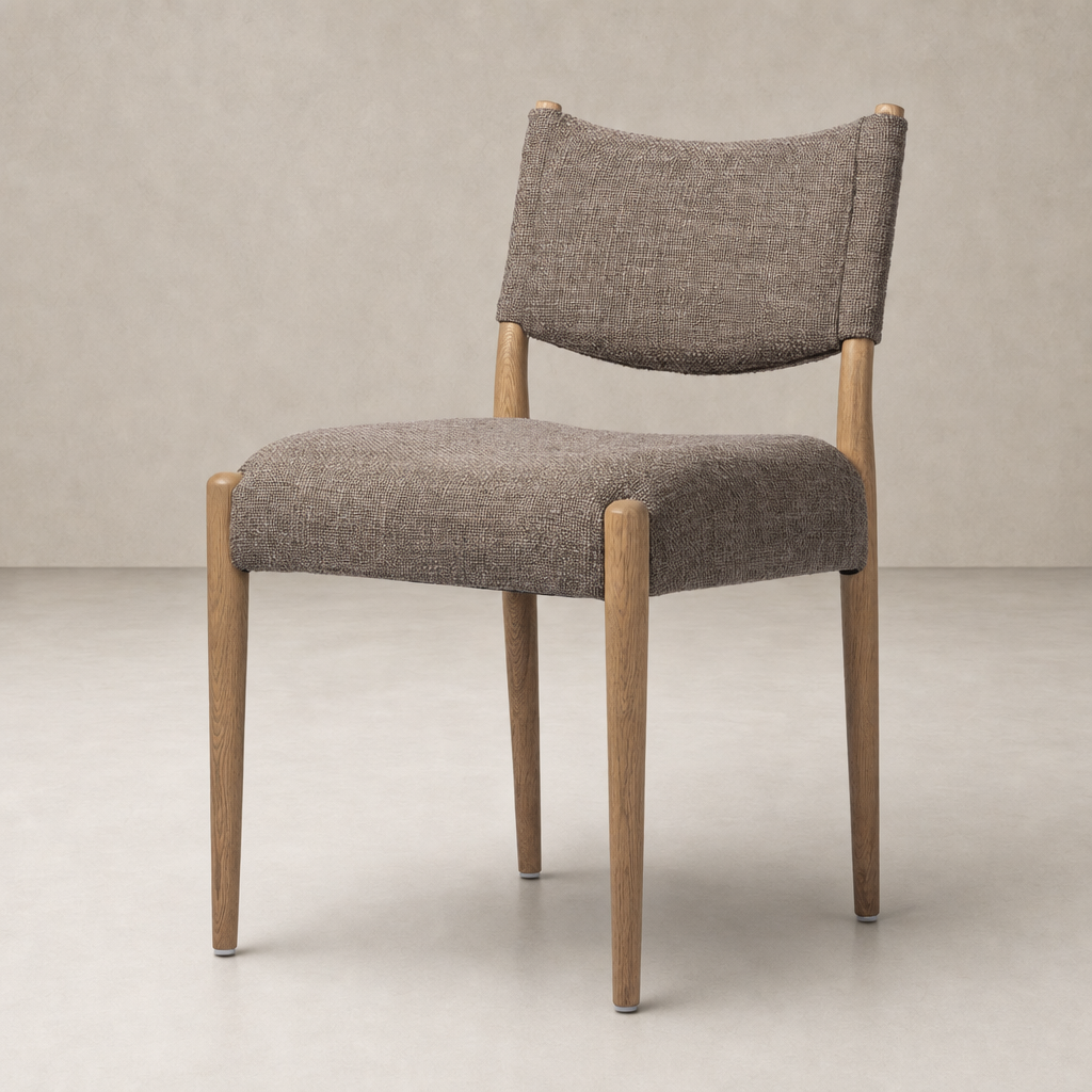 Mira Armless Dining Chair in Saxon Mink with curved back and wooden legs.