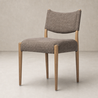 Mira Armless Dining Chair in Saxon Mink with curved back and wooden legs.