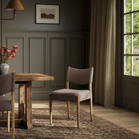 Mira Armless Dining Chair in Saxon Mink with minimalist design, set in a cozy dining area.