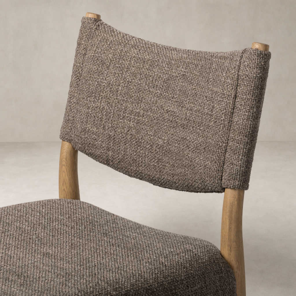 Mira Armless Dining Chair in Saxon Mink features a textured fabric and natural wood legs.