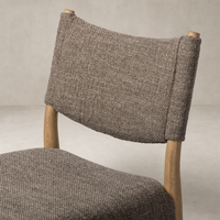 Mira Armless Dining Chair in Saxon Mink features a textured fabric and natural wood legs.