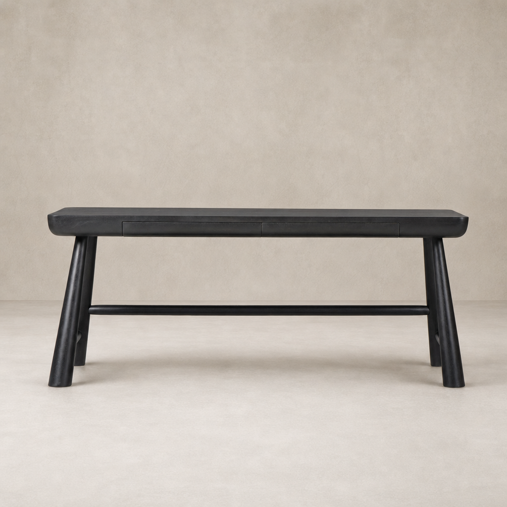 Koa Desk in worn black acacia features a sleek design with sturdy angled legs.