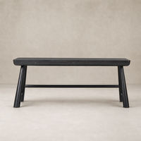 Koa Desk in worn black acacia features a sleek design with sturdy angled legs.