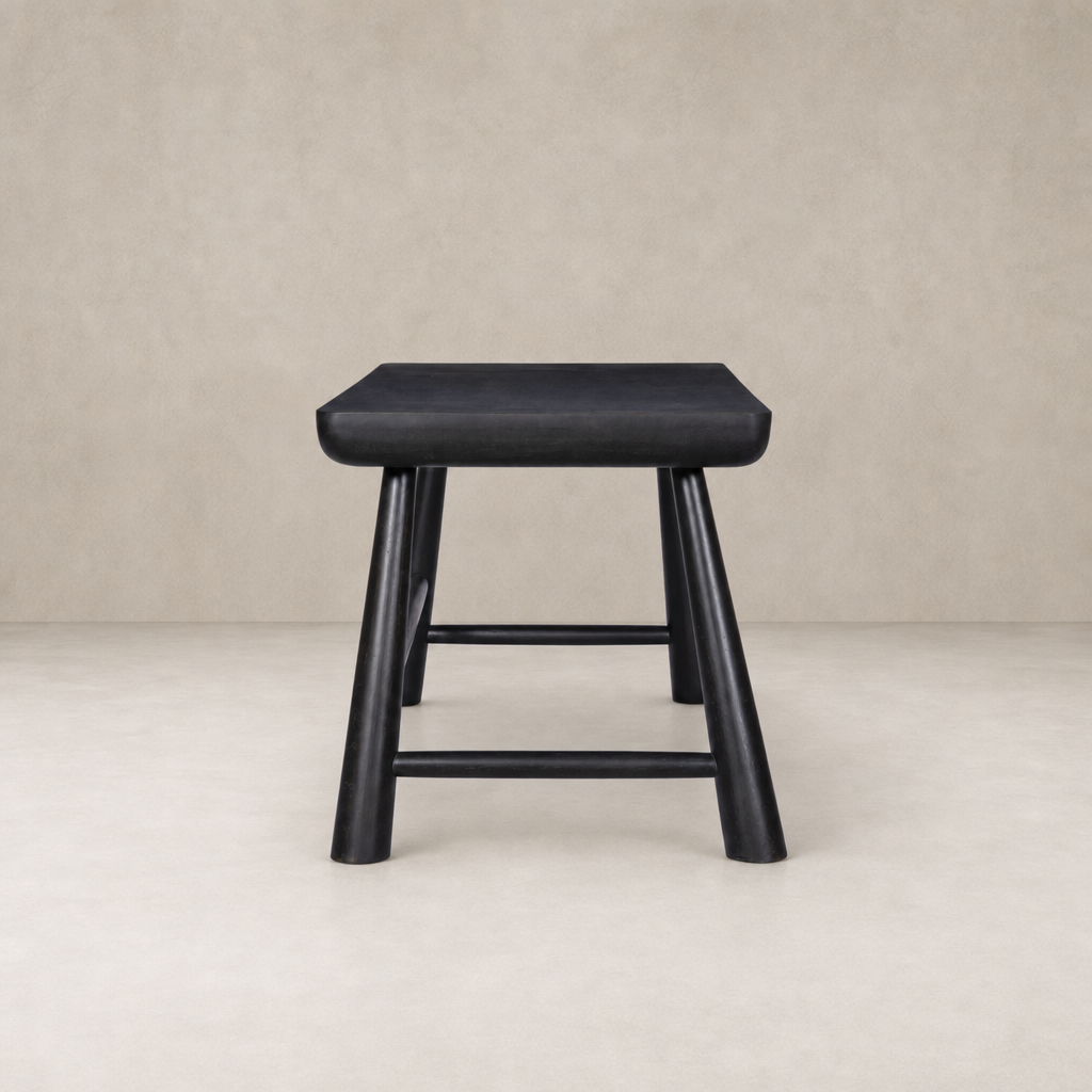 Koa Desk in worn black acacia features rounded edges and sturdy legs.