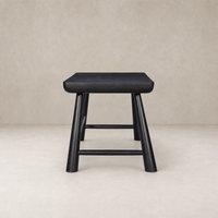 Koa Desk in worn black acacia features rounded edges and sturdy legs.