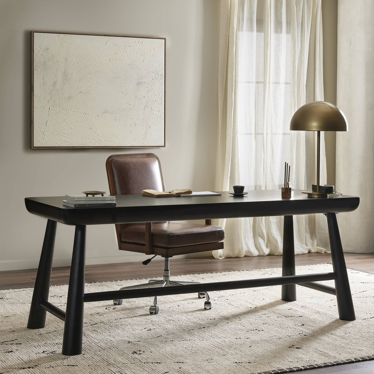 Koa Desk in worn black acacia with a sleek, modern design and sturdy legs.