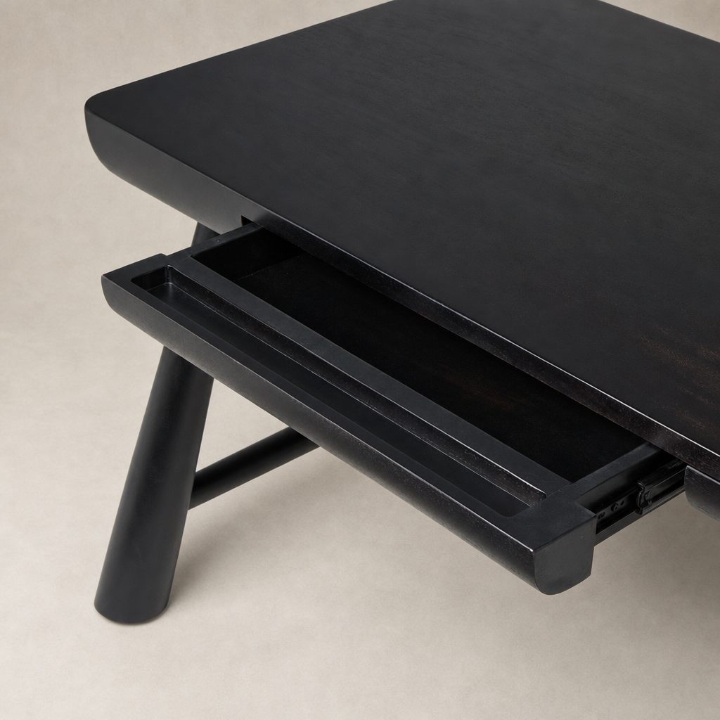Koa Desk in worn black acacia featuring a sleek design and functional drawer.