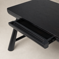 Koa Desk in worn black acacia featuring a sleek design and functional drawer.
