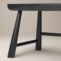 Koa Desk featuring worn black acacia with sleek angled legs and subtle drawer.
