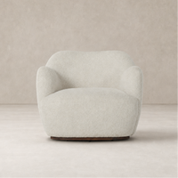 Poppy Swivel Chair in Sheldon Ivory featuring a rounded, plush design and soft texture.