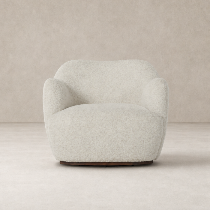 Poppy Swivel Chair in Sheldon Ivory featuring a rounded, plush design and soft texture.