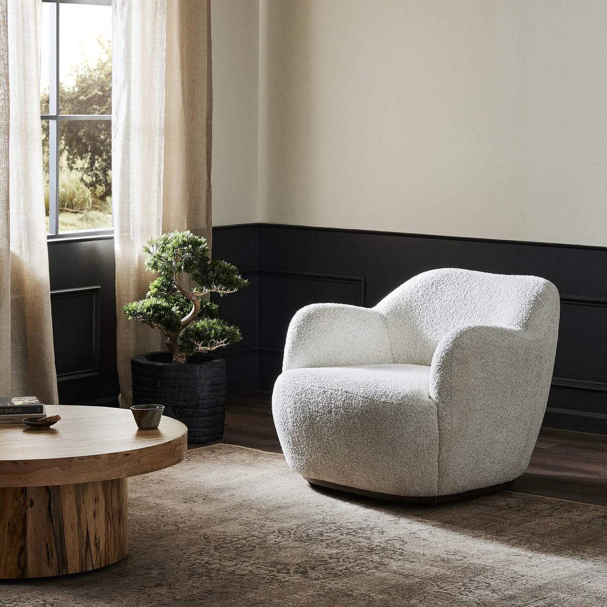 Poppy Swivel Chair in Sheldon Ivory featuring a soft, textured finish in a cozy living room setting.