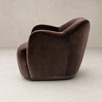 Poppy Swivel Chair in Surrey Cocoa featuring a sleek, curved design and soft upholstery.