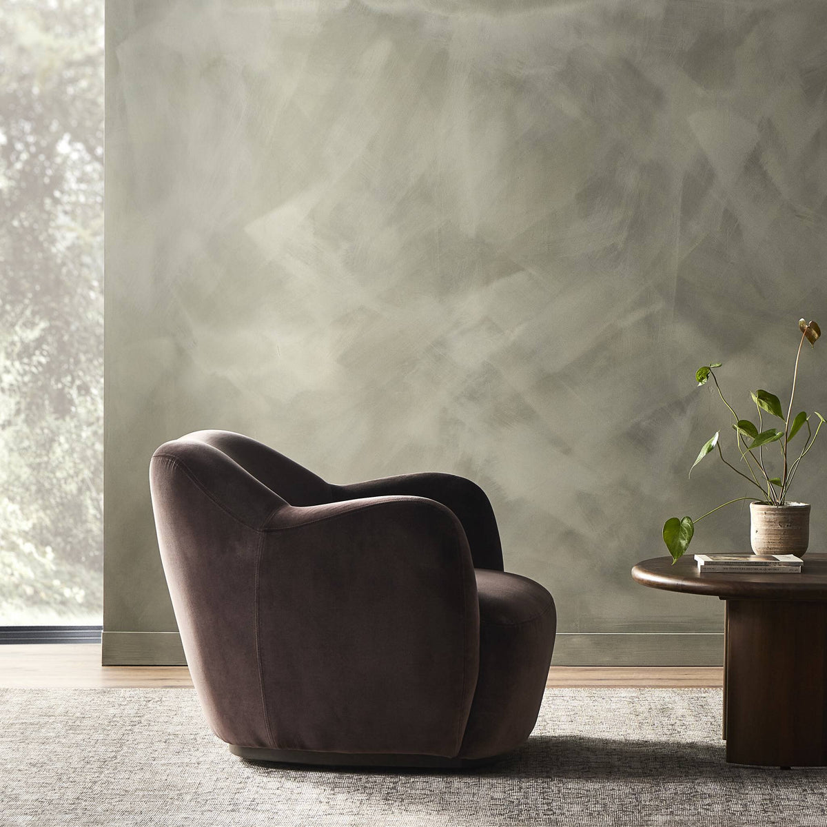 Poppy Swivel Chair in Surrey Cocoa featuring a sleek, plush design against a soft background.