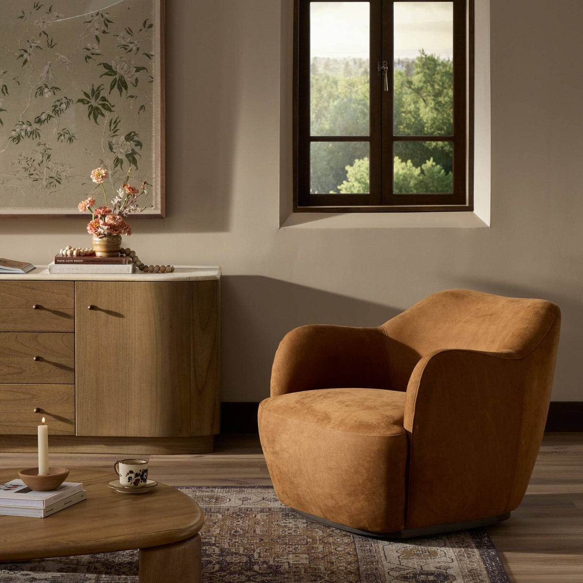 Poppy Swivel Chair in Nubuck Cognac, featuring a cozy curved design.