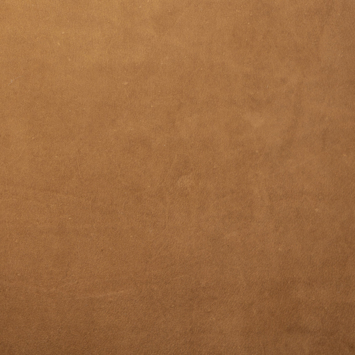 Nubuck cognac texture of the Poppy Swivel Chair, showcasing its soft finish.
