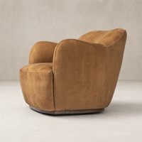 Poppy Swivel Chair in Nubuck Cognac with rounded arms and plush seat.