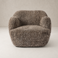 Poppy Swivel Chair in taupe shearling with plush, textured upholstery and rounded design.