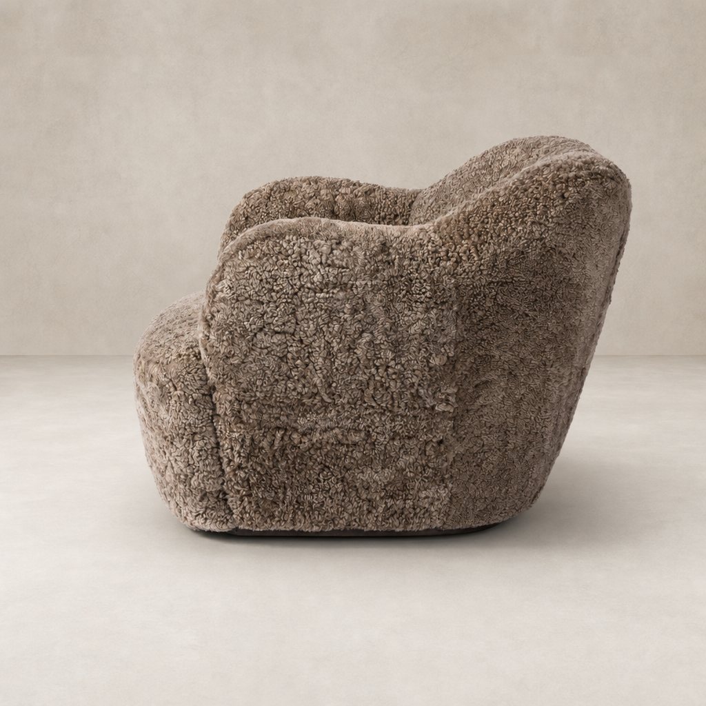 Poppy Swivel Chair in taupe shearling with a cozy, rounded shape.