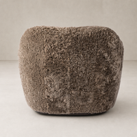 Poppy Swivel Chair in taupe shearling featuring a plush, rounded design.